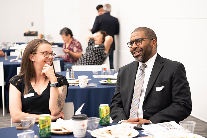 ASF Scholar Awards Reception black man and white woman smiling at dining table